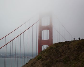 View of suspension bridge in foggy weather