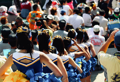 Rear view of people sitting in row