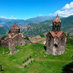 Traditional building by mountains against sky