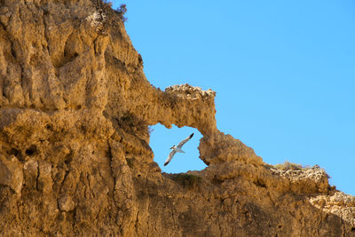 Low angle view of rock formation against clear sky