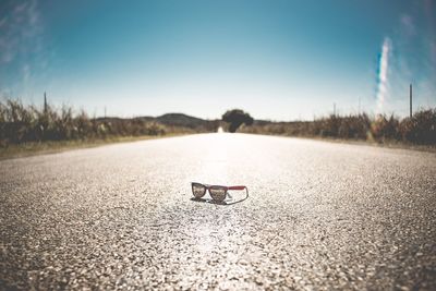 View of abandoned car on landscape against sky