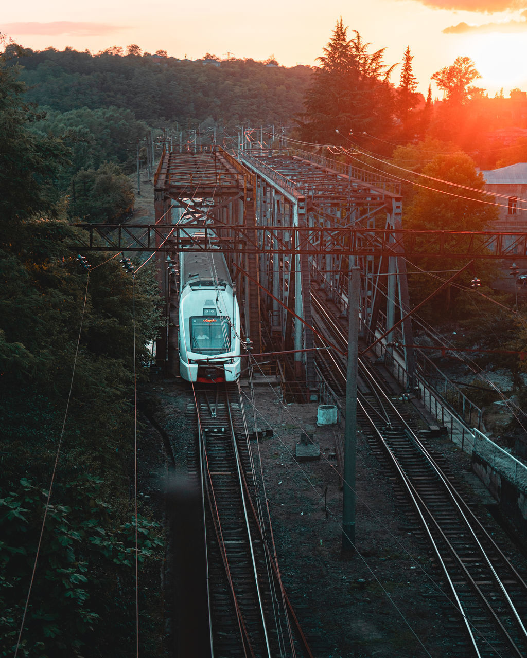 HIGH ANGLE VIEW OF TRAIN AT RAILROAD TRACKS