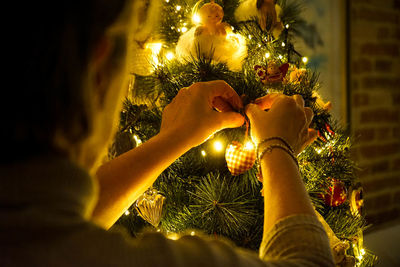 Midsection of illuminated christmas tree