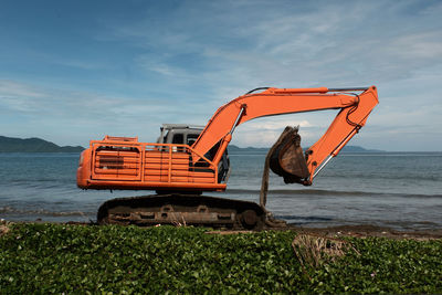 Scenic view of sea against sky and the excavators