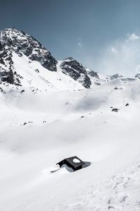 Scenic view of snow covered mountain against sky