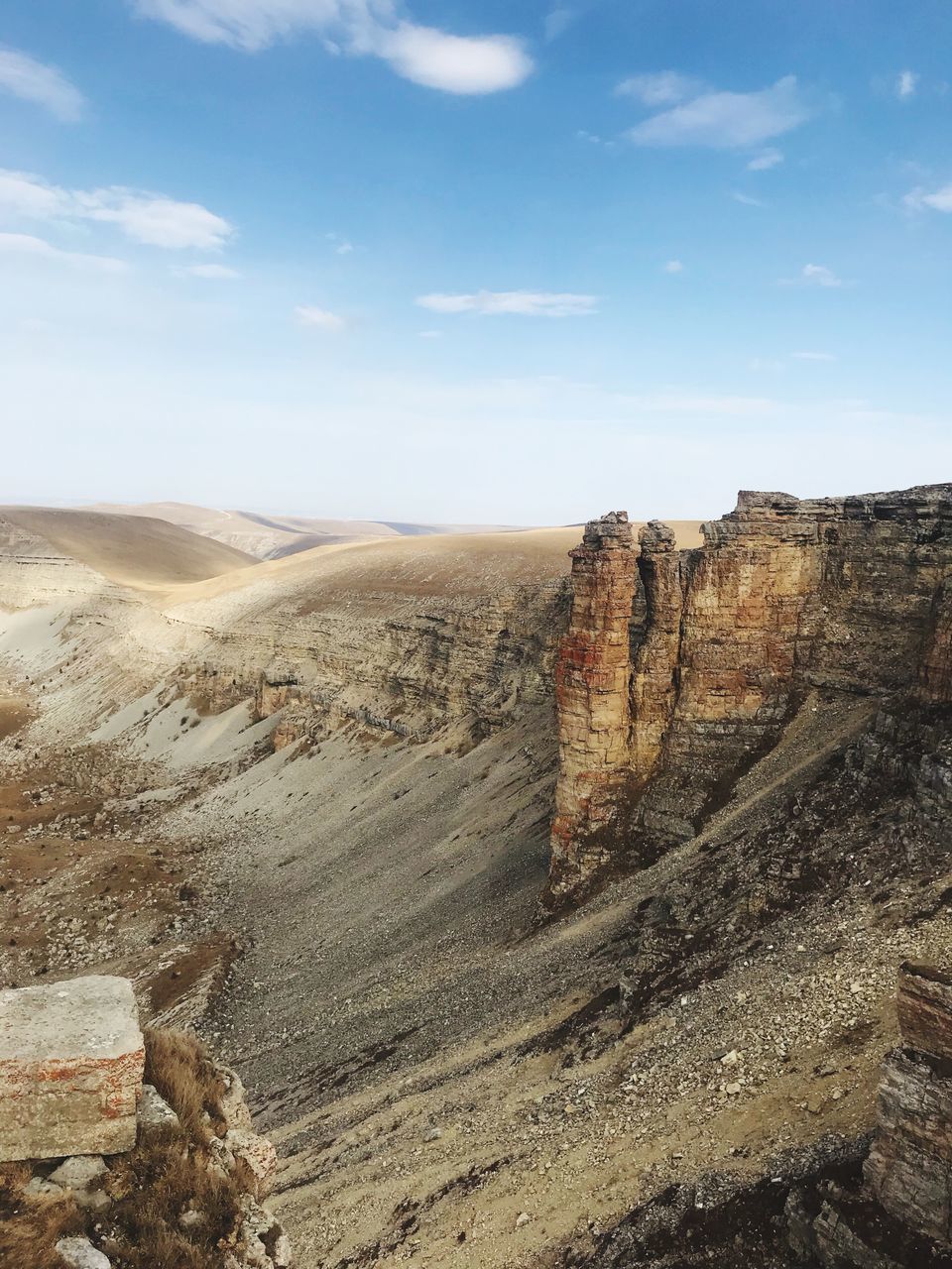 sky, tranquil scene, cloud - sky, scenics - nature, tranquility, environment, non-urban scene, beauty in nature, landscape, nature, no people, day, travel destinations, rock, land, mountain, idyllic, remote, rock formation, rock - object, outdoors, eroded, arid climate