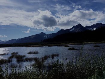 Calm lake against mountain range