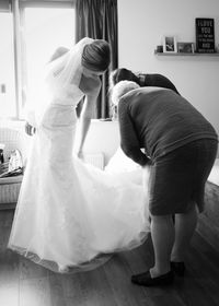 Rear view of mother with daughter standing on floor