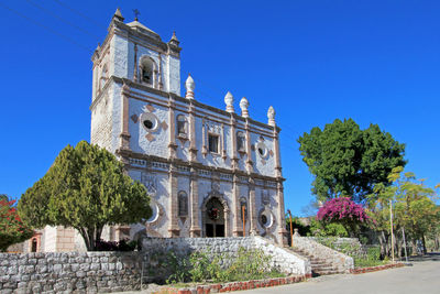 Low angle view of historical building against blue sky