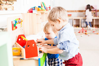 Cute kids playing with toys at school