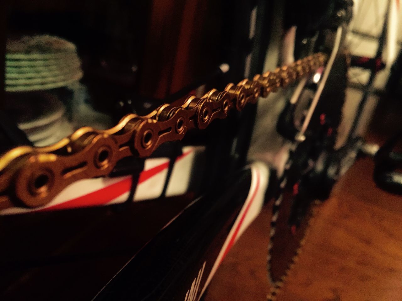 CLOSE-UP OF GUITAR ON TABLE IN ILLUMINATED ROOM