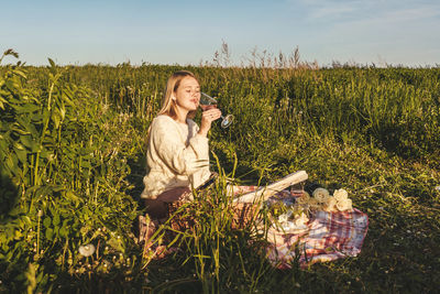 Woman in field against sky