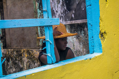 Woman standing by wall