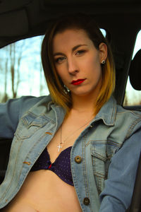 Portrait of confident beautiful woman in car