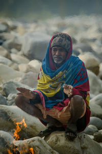 Portrait of a smiling woman sitting outdoors