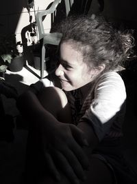 Close-up of girl sitting at balcony