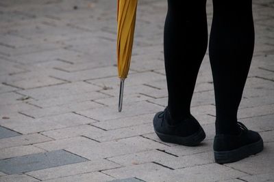 Low section of person standing on street