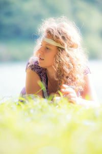 Close-up of woman lying on field