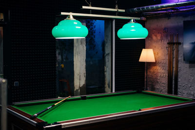 Illuminated pendant lights hanging on table
