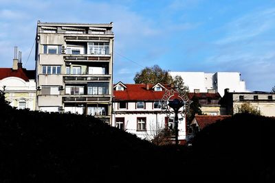 Low angle view of buildings in town against sky