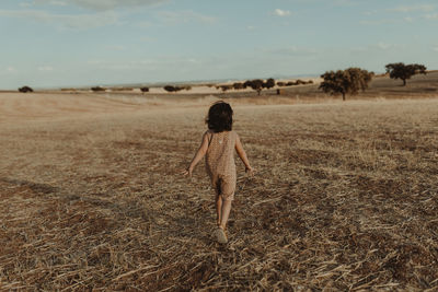 Child running through the fields