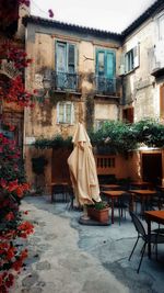 Chair on table by buildings in city