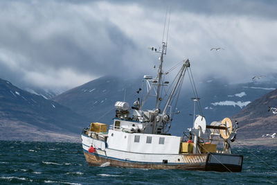 Ship moored in sea against sky