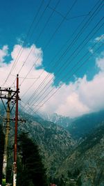 Low angle view of power lines against clear sky