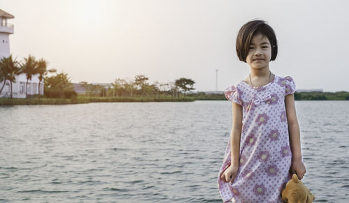 Full length of girl standing in water
