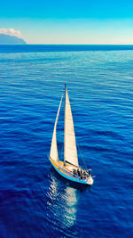 Sailboat sailing in sea against sky