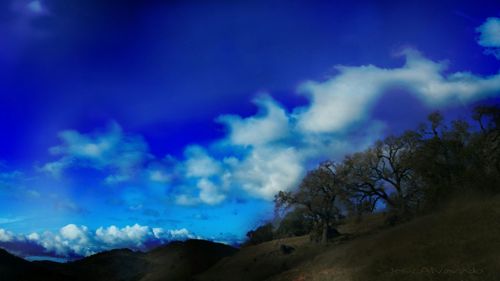 Scenic view of mountains against blue sky