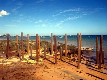 Scenic view of beach against blue sky