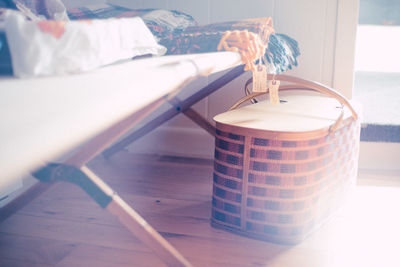 Basket by furniture in room at home