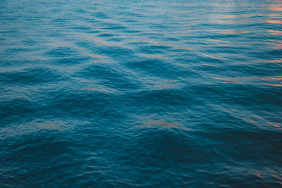 Full frame shot of waves in sea during sunset