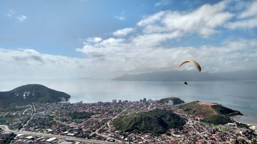 Scenic view of sea and cityscape against sky