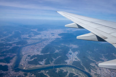 Aerial view of airplane flying in sky