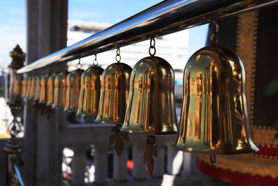 Close-up of wine bottles hanging at market stall