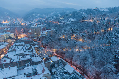 High angle view of townscape and mountains during winter