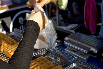 Midsection of woman receiving food at store