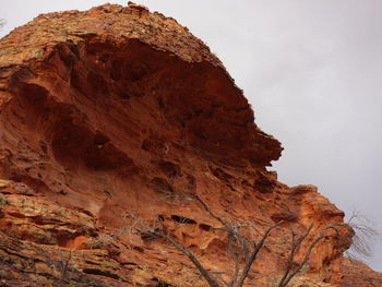 Low angle view of rock formation against sky