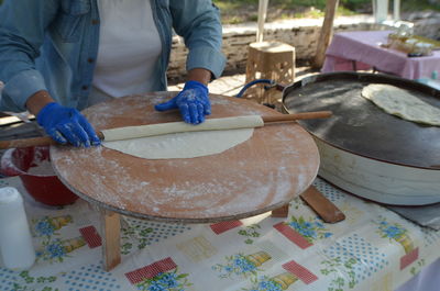 Midsection of man preparing food on table