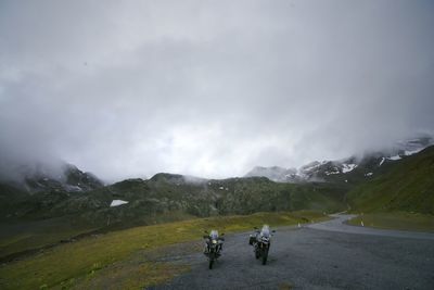 Scenic view of mountains against cloudy sky