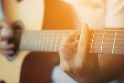 Close-up of hands playing guitar