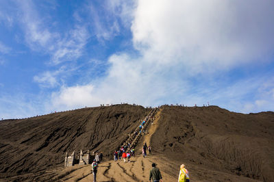 People on bromo mountain against sky
