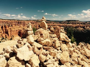 Rock formations on landscape against sky