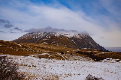 Scenic view of snowcapped mountains against sky