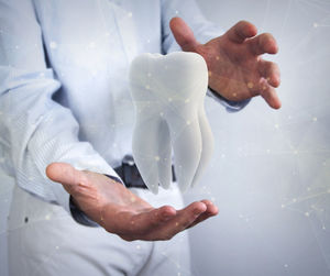 Digital composite image of dentist reaching teeth and connecting dots