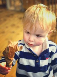 Toddler boy holding an autumn leaf