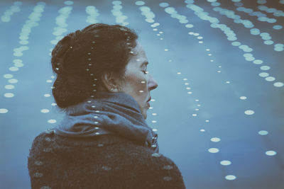 Woman on the shore of a lake surrounded by lights ii