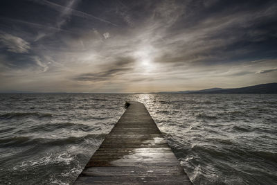 Pier over sea against sky